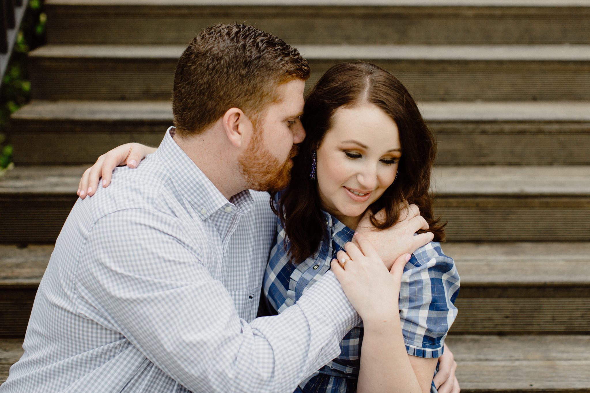 couple in blue plaid sitting on stairs