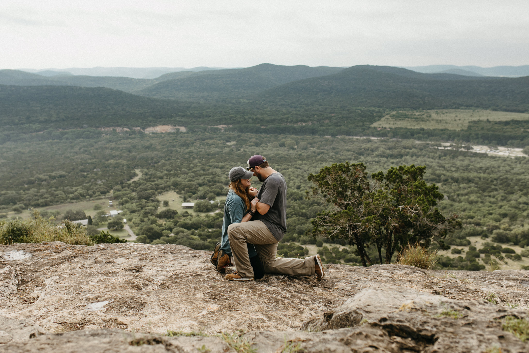 man proposing to woman on top of old baldy at garner state park