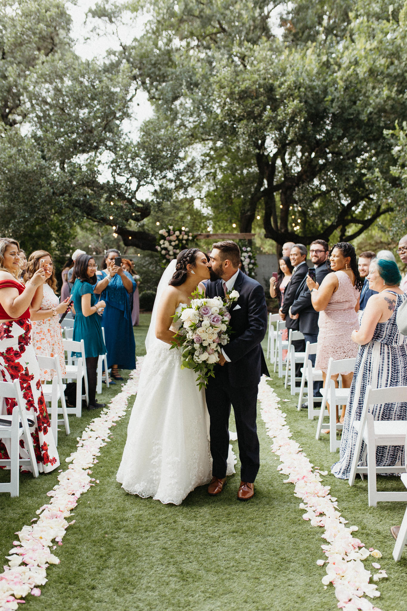 bride and groom kissing at the end of the aisle san antonio photographer leah thomason