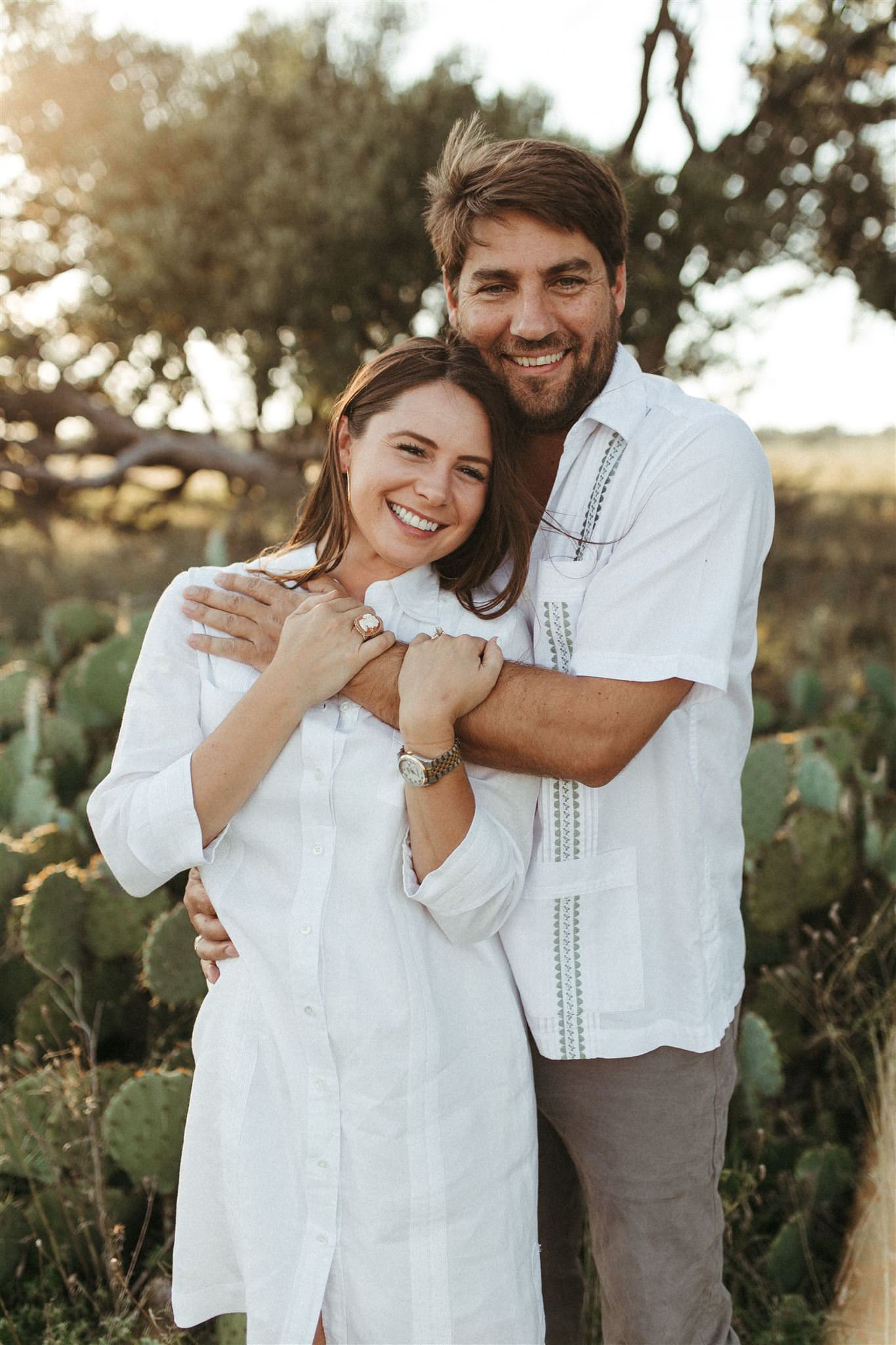 engaged couple posing in front of cactus texas photographer Leah Thomason