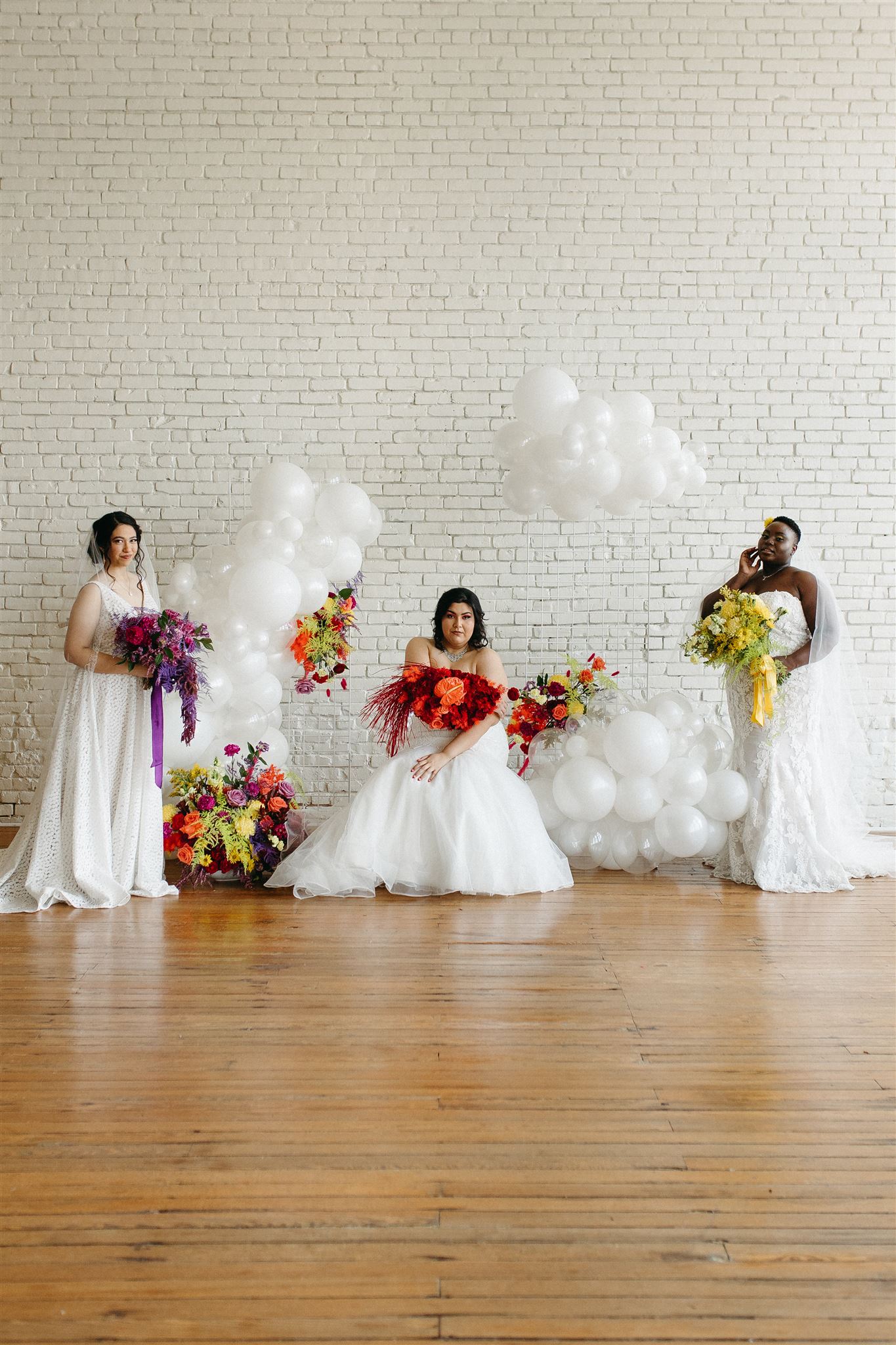 plus size brides with white balloons and vibrant florals