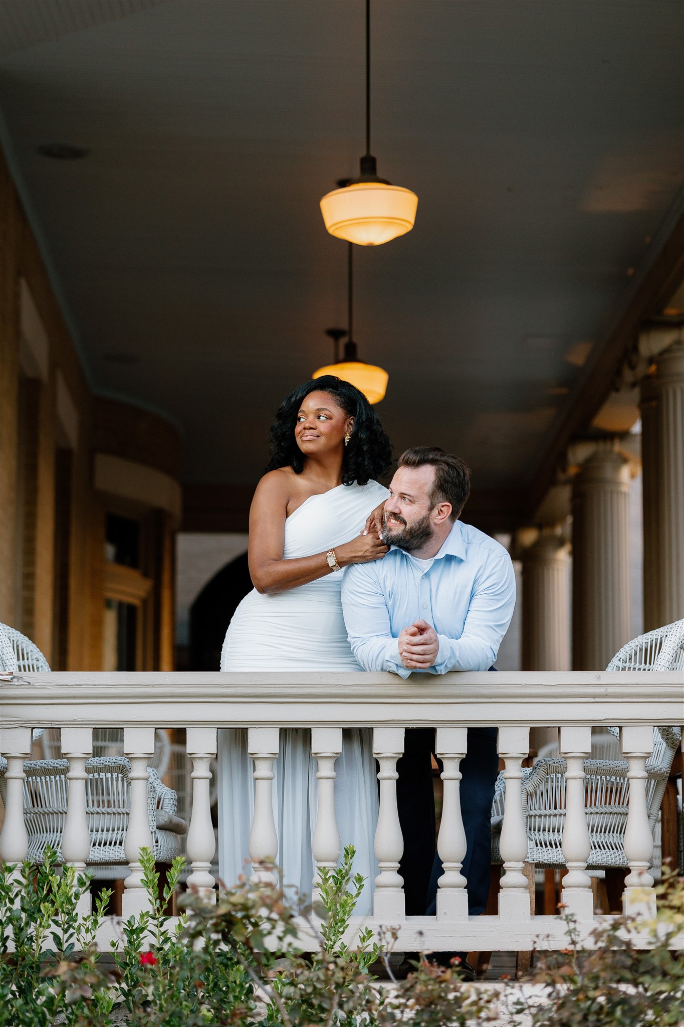 couple posing on the front porch of hotel Ella in Austin texas