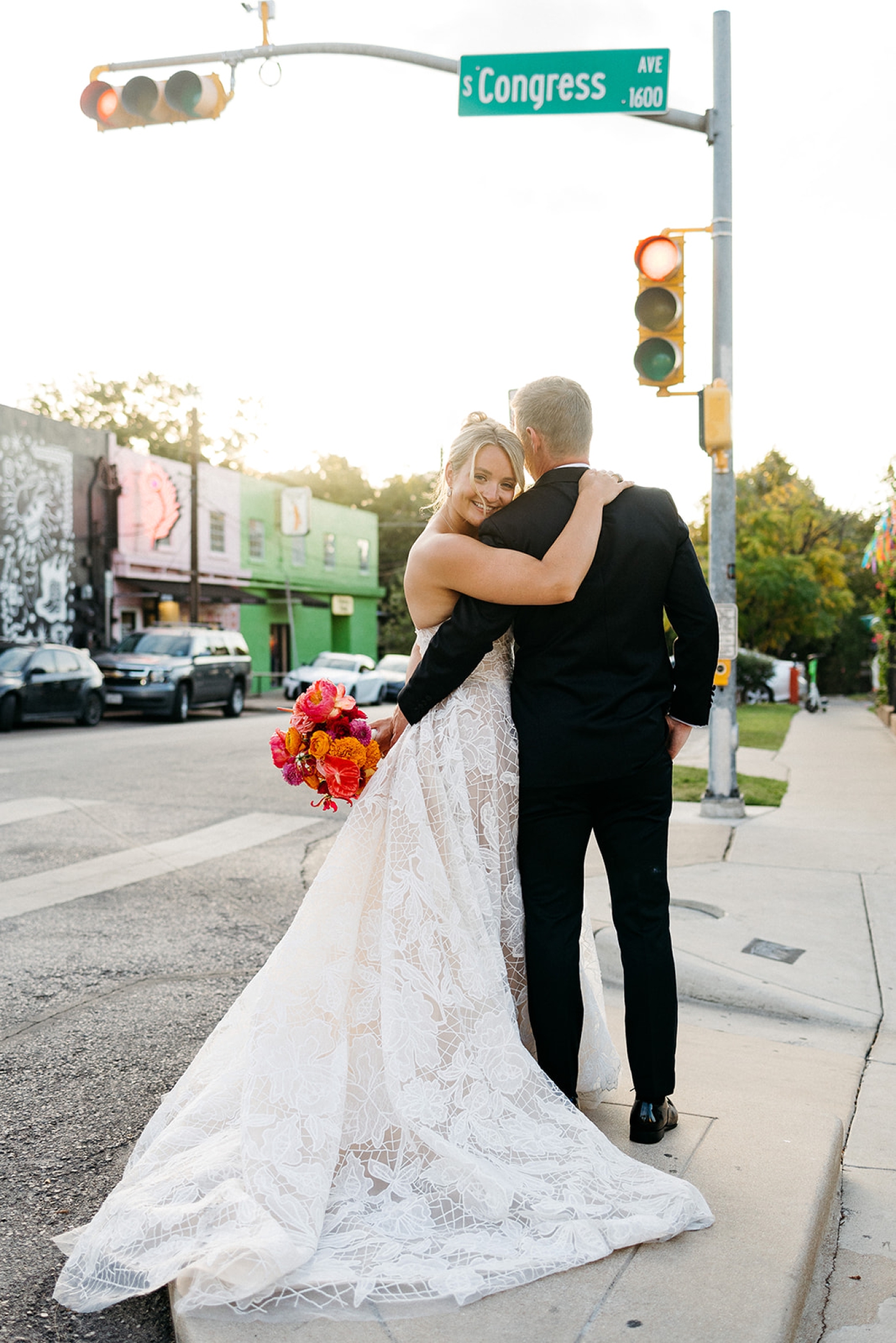 A bride and groom stand on the corner of South Congress Street in Austin, Texas