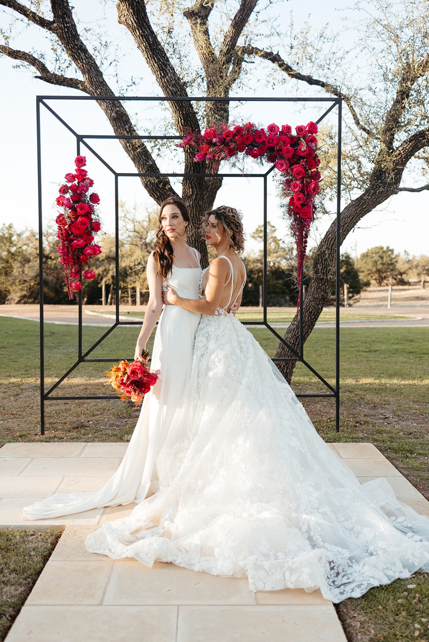 Brides embrace during their wedding cermomy at Willow Sky Ranch, an inclusive, LGBT friendly wedding venue
