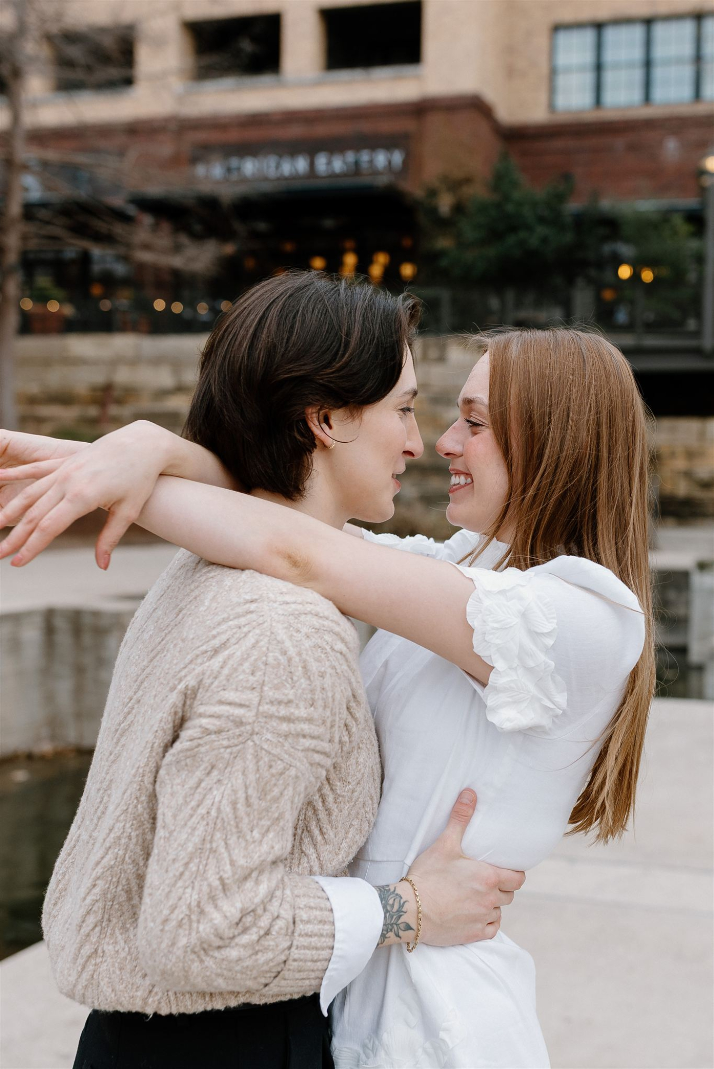 lesbian couple hugging at the the pearl in san antonio
